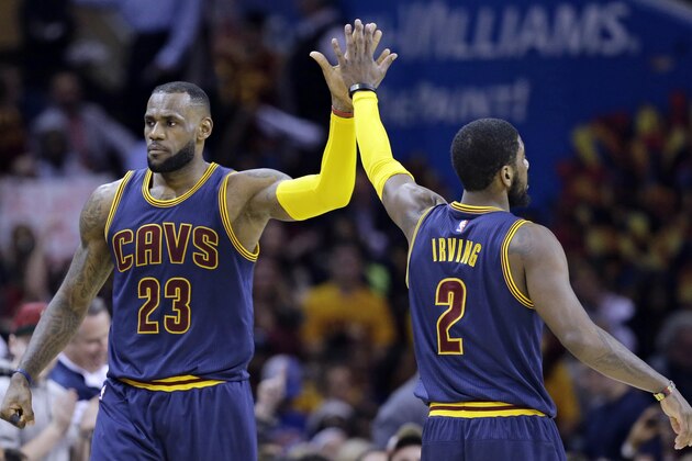 Cleveland Cavaliers' LeBron James (23) and Kyrie Irving (2) celebrate during an NBA basketball game against the Miami Heat Thursday, April 2, 2015, in Cleveland. (AP Photo/Tony Dejak)
