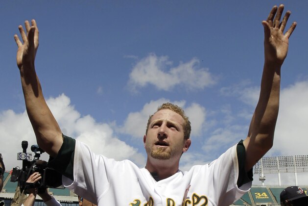 Oakland Athletics starting pitcher Dallas Braden celebrates after throwing a perfect game against the Tampa Bay Rays during a baseball game in Oakland, Calif., Sunday, May 9, 2010. Oakland won 4-0. (AP Photo/Marcio Jose Sanchez)