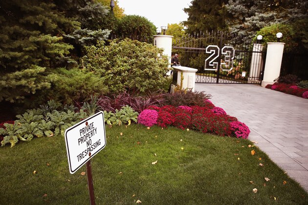 HIGHLAND PARK, IL - OCTOBER 21:  A gate with the number 23 controls access to the home of basketball legend Michael Jordan on October 21, 2013 in Highland Park, Illinois. Twenty-three is the number Jordan wore while playing basketball for the Chicago Bulls. The home which had been offered for sale for $29 million and later dropped to $21 million is scheduled to be sold at auction on November 22. The 32,683-squre-foot home features nine bedrooms, 19 bathrooms, a 15-car attached garage and an