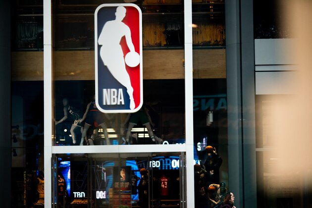 NEW YORK, NY - MARCH 12: An NBA logo is shown at the 5th Avenue NBA store on March 12, 2020 in New York City. The National Basketball Association said they would suspend all games after player Rudy Gobert of the Utah Jazz reportedly tested positive for the Coronavirus (COVID-19). (Photo by Jeenah Moon/Getty Images) NEW YORK, NY - MARCH 12: An NBA logo is shown at the 5th Avenue NBA store on March 12, 2020 in New York City. The National Basketball Association said they would suspend all games after player Rudy Gobert of the Utah Jazz reportedly tested positive for the Coronavirus (COVID-19). (Photo by Jeenah Moon/Getty Images)