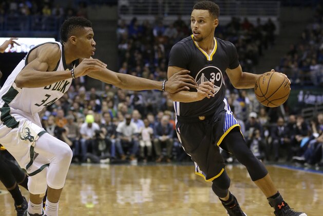 Golden State Warriors' Stephen Curry (30) dribbles against Milwaukee Bucks' Giannis Antetokounmpo during the first half of an NBA basketball game Saturday, Nov. 19, 2016, in Milwaukee. (AP Photo/Aaron Gash)