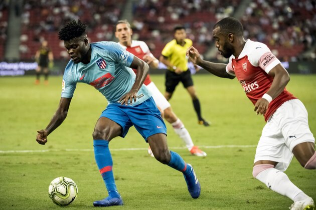SINGAPORE,SINGAPORE - JULY 26: Thomas Partey of Club Atletico de Madrid battles for the ball with Alexandre Lacazette of Arsenal  during the International Champions Cup 2018 match between Arsenal and Club Atletico de Madrid (Photo by PictoBank/Getty Images)