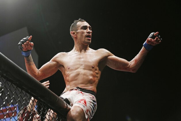 Tony Ferguson celebrates after defeating Edson Barboza in a lightweight bout during The Ultimate Fighter finale Friday, Dec. 11, 2015, in Las Vegas. (AP Photo/John Locher)