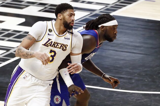 LOS ANGELES, CA - MARCH 8: Montrezl Harrell #5 of the LA Clippers fights for position with Anthony Davis #3 of the Los Angeles Lakers during a game at the Staples Center on March 8, 2020 in Los Angeles, CA. NOTE TO USER: User expressly acknowledges and agrees that, by downloading and or using this photograph, User is consenting to the terms and conditions of the Getty Images License Agreement. Mandatory Credit: 2020 NBAE (Photo by Chris Elise/NBAE via Getty Images)