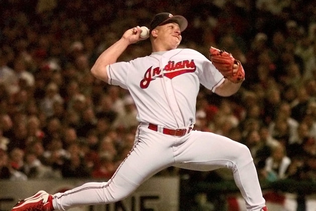 FILE - In this Oct. 9, 1998, file photo, Cleveland Indians pitcher Bartolo Colon delivers a pitch against the New York Yankees in the first inning of Game 3 of the American League championship series in Cleveland. Colon turns 42 on Sunday, and in his 18th year in the major leagues, the Dominican is showing pinpoint accuracy and an uncanny ability to get outs with one pitch: a low-90’s fastball. (AP Photo/Beth A. Keiser, File)