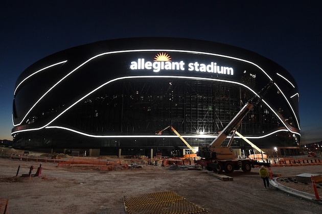 LAS VEGAS, NEVADA - APRIL 23:  Crews test out architectural light ribbons and exterior sign lighting as construction continues at Allegiant Stadium, the USD 2 billion, glass-domed future home of the Las Vegas Raiders on April 23, 2020 in Las Vegas, Nevada. The Raiders and the UNLV Rebels football teams are scheduled to begin play at the 65,000-seat facility in their 2020 seasons.  (Photo by Ethan Miller/Getty Images)
