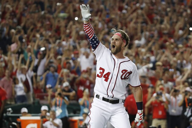 FILE - In this July 16, 2018, file photo, Washington Nationals Bryce Harper (34) reacts to his winning hit during the Major League Baseball Home Run Derby, in Washington. A person familiar with the negotiations tells The Associated Press that Bryce Harper and the Philadelphia Phillies have agreed to a $330 million, 13-year contract, the largest deal in baseball history. The person spoke to the AP on condition of anonymity Thursday, Feb. 28, 2019,  because the agreement is subject to a successful physical. (AP Photo/Alex Brandon, File)