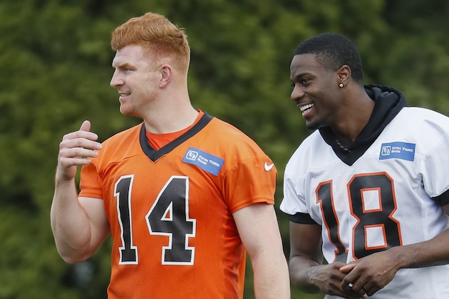 Cincinnati Bengals quarterback Andy Dalton, left, and wide receiver A.J. Green, right, share a laugh during voluntary football minicamp, Tuesday, April 23, 2019, in Cincinnati. (AP Photo/John Minchillo)
