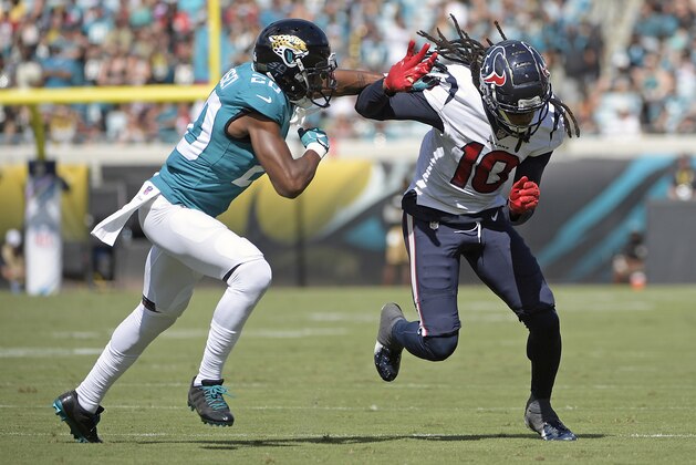 Houston Texans wide receiver DeAndre Hopkins (10) runs past Jacksonville Jaguars cornerback Jalen Ramsey, left, on a pattern during the first half of an NFL football game, Sunday, Oct. 21, 2018, in Jacksonville, Fla. (AP Photo/Phelan M. Ebenhack)