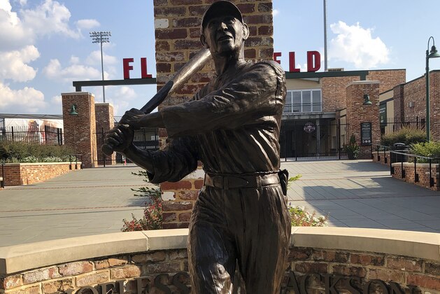 In this Sept. 29, 2019, photo, a statue of Shoeless Joe Jackson stands in front Fluor Stadium in Greenville, S.C. (AP Photo/Paul Newberry)