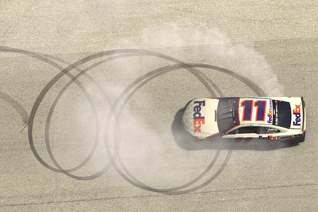 HOMESTEAD, FLORIDA - MARCH 22: (EDITORIAL USE ONLY) (Editors note: This image was computer generated in-game).  Denny Hamlin, driver of the #11 FedEx Toyota, celebrates after winning the eNASCAR iRacing Pro Invitational Series Dixie Vodka 150 at virtual Homestead-Miami Speedway on March 22, 2020 in Homestead, Florida. (Photo by Chris Graythen/Getty Images) (Photo by Chris Graythen/Getty Images)