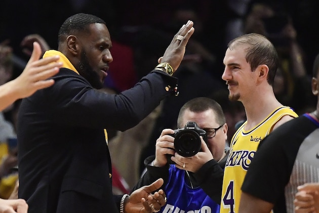 Los Angeles Lakers forward LeBron James, left, congratulates guard Alex Caruso after the Lakers defeated the Los Angeles Clippers 122-117 in an NBA basketball game Friday, April 5, 2019, in Los Angeles. (AP Photo/Mark J. Terrill)