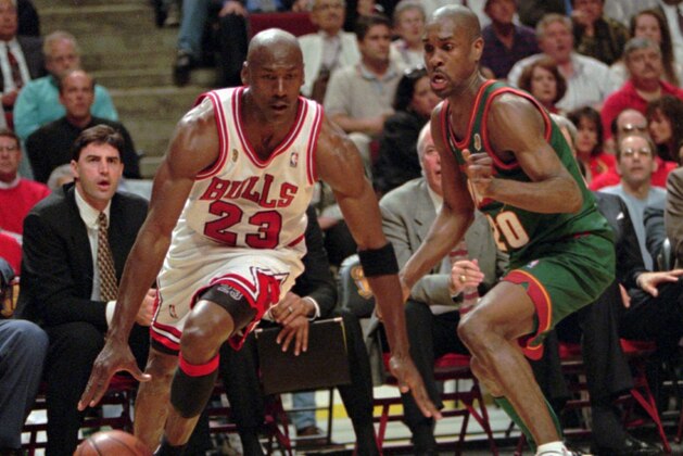 Chicago Bulls' Michael Jordan drives around Seattle SuperSonics' Gary Payton during Game 1 of the NBA Finals Wednesday night, June 5, 1996, in Chicago. The Bulls won 107-90 and the much anticipated matchup of Jordan and Payton in the series opener was well worth the wait. (AP Photo/Beth A. Keiser)