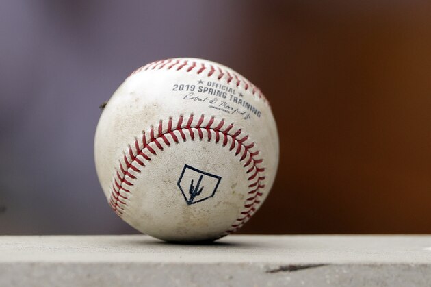 A spring training baseball ball with a Cactus League logo sits on a dugout wall during a game between the Arizona Diamondbacks and Los Angeles Angels Thursday, March 21, 2019, in Scottsdale, Ariz. (AP Photo/Elaine Thompson)