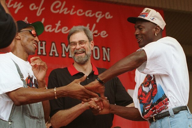 Chicago's Bulls' Scottie Pippen, left, coach Phil Jackson, and Michael Jordan, share a three-way victory handshake during the NBA Championship celebration at Chicago's Grant Park Tuesday, June 18, 1996. Thousands of fans gathered for a personal pledge of allegiance to their hometown heroes who clinched the Chicago team's fourth NBA Championship title with Sunday's win over the Seattle SuperSonics. (AP Photo/Beth Keiser)