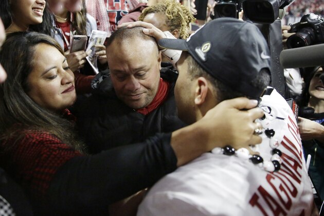 Alabama's Tua Tagovailoa celebrates with his parents Galu and Diane after overtime of the NCAA college football playoff championship game against Georgia Monday, Jan. 8, 2018, in Atlanta. Alabama won 26-23. (AP Photo/David Goldman)