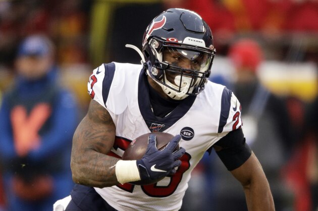 Houston Texans running back Carlos Hyde (23) carries the ball during the first half of an NFL divisional playoff football game against the Kansas City Chiefs, in Kansas City, Mo., Sunday, Jan. 12, 2020. (AP Photo/Charlie Riedel)
