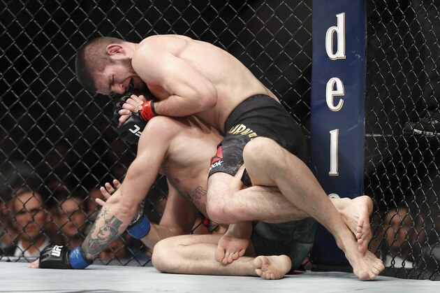 Khabib Nurmagomedov, top, applies a rear naked choke hold to Conor McGregor during a lightweight title mixed martial arts bout at UFC 229 in Las Vegas, Saturday, Oct. 6, 2018. Nurmagomedov won the fight by submission during the fourth round to retain the title. (AP Photo/John Locher)