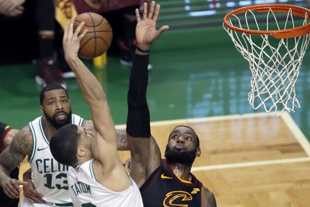 Boston Celtics forward Jayson Tatum dunks against Cleveland Cavaliers forward LeBron James, right, during the second half in Game 7 of the NBA basketball Eastern Conference finals, Sunday, May 27, 2018, in Boston. (AP Photo/Charles Krupa)