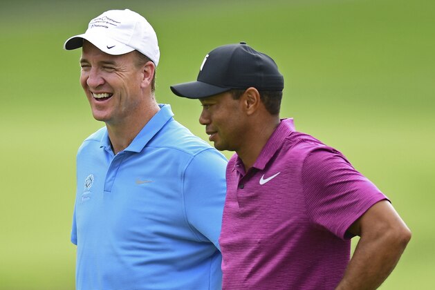 Peyton Manning, left, laughs while talking with Tiger Woods on the eleventh hole during the pro-am for the the Memorial golf tournament Wednesday, May 30, 2018, in Dublin, Ohio. (AP Photo/David Dermer)