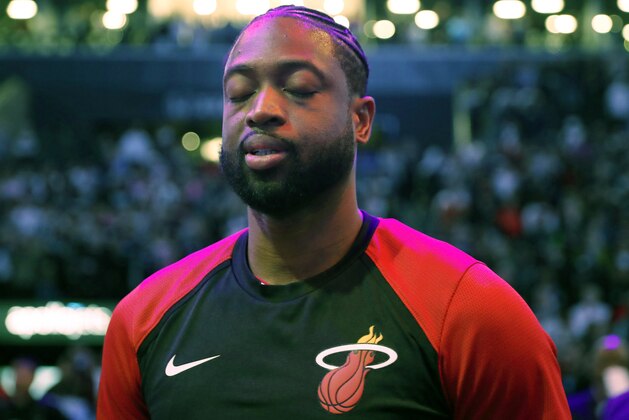 Miami Heat guard Dwyane Wade observes a moment of silence during the National Anthem before the final NBA basketball game of his career, Wednesday, April 10, 2019, against the Brooklyn Nets in New York. (AP Photo/Kathy Willens)