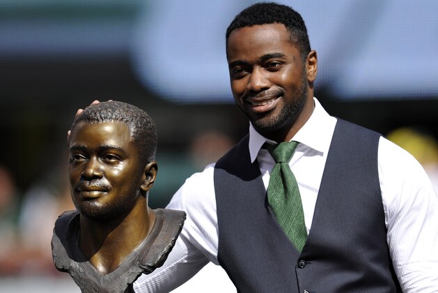 Hall of Famer Curtis Martin poses with his bust as he is honored at halftime of an NFL football game between the New York Jets and the Buffalo Bills, Sunday, Sept. 9, 2012, in East Rutherford, N.J. (AP Photo/Bill Kostroun)