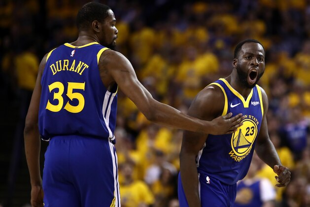 OAKLAND, CALIFORNIA - APRIL 24:  Draymond Green #23 of the Golden State Warriors reacts to a call as Kevin Durant #35 holds him back during their game against the LA Clippers during Game Five of the first round of the 2019 NBA Western Conference Playoffs at ORACLE Arena on April 24, 2019 in Oakland, California. NOTE TO USER: User expressly acknowledges and agrees that, by downloading and or using this photograph, User is consenting to the terms and conditions of the Getty Images License Agreement. (Photo by Ezra Shaw/Getty Images)