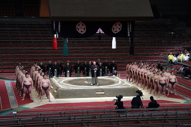 Sumo Association chairman Hakkaku (C) greets sumo wrestlers during the spring grand sumo tournament held behind closed doors due to the outbreak of the COVID-19 coronavirus, in Edion Arena Osaka in Osaka on March 8, 2020. - Sumo's spring tournament began behind closed doors, the latest big event in Japan to be hit by the coronavirus less than five months before the Tokyo Olympics. (Photo by STR / JIJI PRESS / AFP) / Japan OUT (Photo by STR/JIJI PRESS/AFP via Getty Images)
