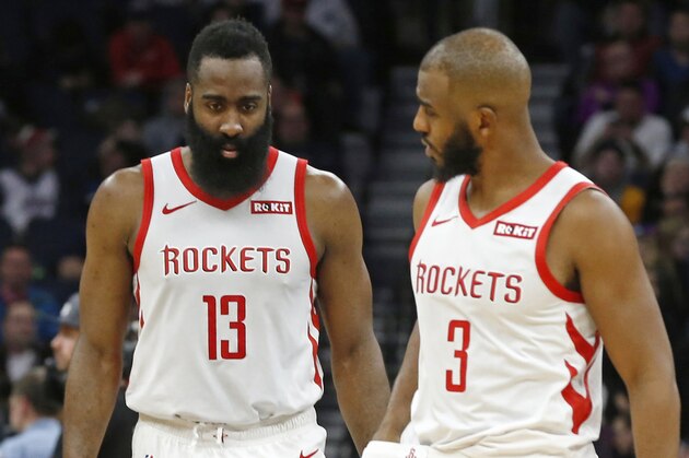 Houston Rockets' James Harden, left, and Chris Paul confer in an NBA basketball game against the Minnesota Timberwolves Wednesday, Feb. 13, 2019, in Minneapolis. (AP Photo/Jim Mone)