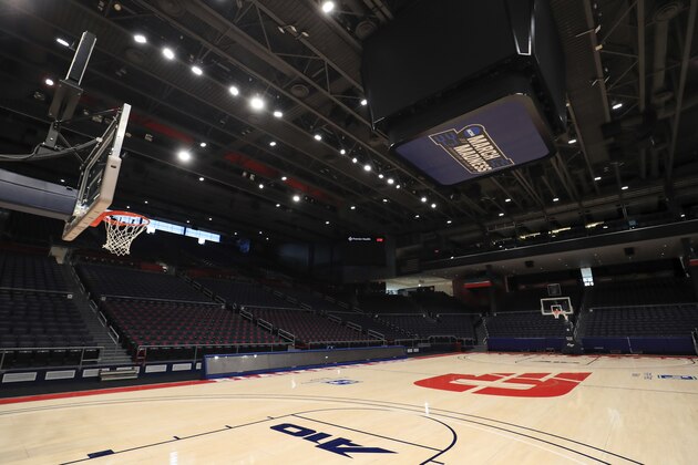 A view of the March Madness logo inside the Dayton Arena, Friday, March 13, 2020, in Dayton, Ohio. The coronavirus outbreak has abruptly roused the University of Dayton from its dream of a basketball season. The 29-2 Flyers were rolling into tournament play on a 20-game winning streak that had lifted spirits in an Ohio city battered in the past year by violent deaths and devastation. The NCAA decision to cancel March Madness ended hopes for the small Roman Catholic school's first Final Four appearance in 53 years. (AP Photo/Aaron Doster)