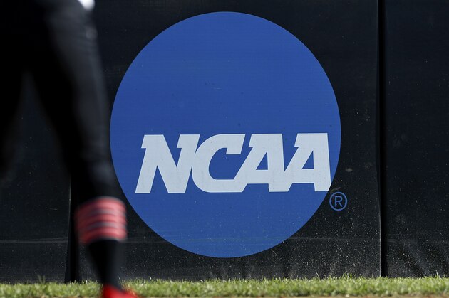 A detail view of the NCAA logo is seen as a Lamar University softball player's cleats are seen in the batter's box during an Northwestern State University at Lamar University NCAA softball game on Friday, April 19, 2019 in Beaumont, Texas. (AP Photo/Aaron M. Sprecher)
