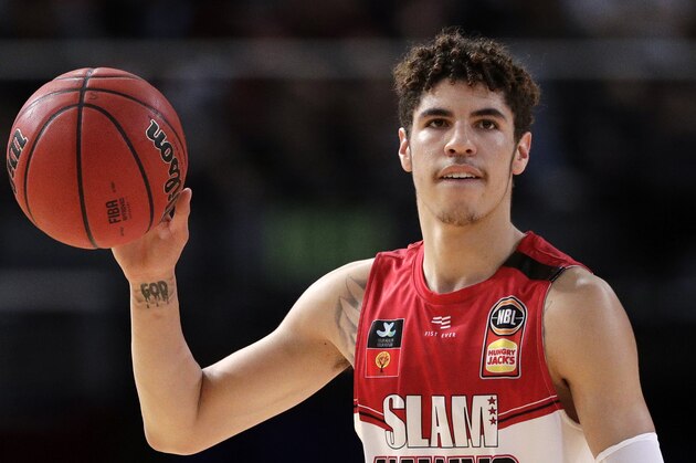 FILE - In this Nov. 17, 2019, file photo, LaMelo Ball of the Illawarra Hawks carries the ball up during their game against the Sydney Kings in the Australian Basketball League in Sydney.  LaMelo Ball's bone bruise on his left foot is expected to keep him out of the Illawarra Hawks lineup for the remainder of the National Basketball League season in Australia. The 18-year-old American, who joined Illawarra as part of the NBL's Next Stars program, is expected to be a first-round pick in this year's NBA draft.(AP Photo/Rick Rycroft, File)