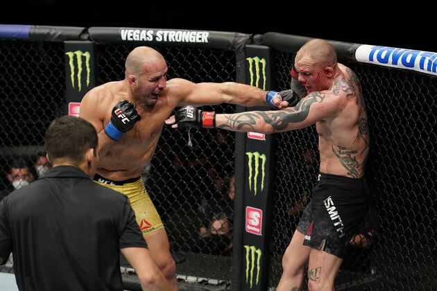 JACKSONVILLE, FLORIDA - MAY 13:  (L-R) Glover Teixeira of Brazil punches Anthony Smith in their light heavyweight bout during the UFC Fight Night Event at VyStar Veterans Memorial Arena on May 13, 2020 in Jacksonville, Florida. (Photo by Cooper Neill/Zuffa LLC via Getty Images)