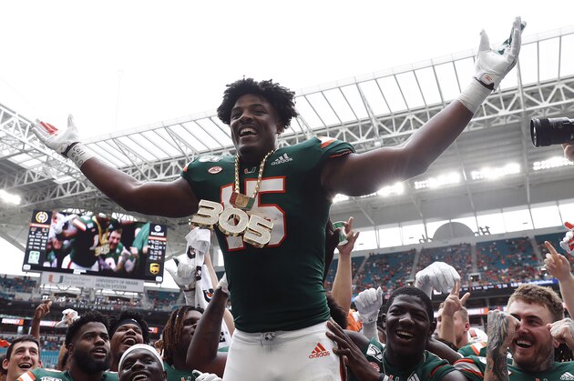 FILE - In this Sept. 21, 2019, file photo, Miami defensive lineman Gregory Rousseau (15) celebrates a turnover and wears the turnover chain during the first half of an NCAA college football game against Central Michigan, in Miami Gardens, Fla. Rousseau was selected to The Associated Press All-Atlantic Coast Conference football team, Tuesday, Dec. 10, 2019. (AP Photo/Brynn Anderson, File)