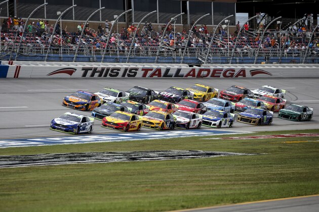 Ryan Blaney (12) leads a pack of cars through the tri-oval during a NASCAR Cup Series auto race at Talladega Superspeedway, Monday, Oct 14, 2019, in Talladega, Ala. (AP Photo/Butch Dill)