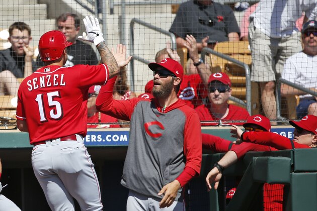Cincinnati Reds' Nick Senzel (15) is greeted as he returns to the dugout following a solo home run in the first inning of a spring training baseball game against the Chicago White Sox, Monday, March 9, 2020, in Glendale, Ariz. (AP Photo/Sue Ogrocki)