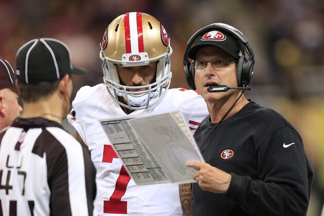 San Francisco 49ers head coach Jim Harbaugh and quarterback Colin Kaepernick (7) talk on the sideline in the fourth quarter of an NFL football game against the St. Louis Rams Monday, Oct. 13, 2014, in St Louis. (AP Photo/Billy Hurst)
