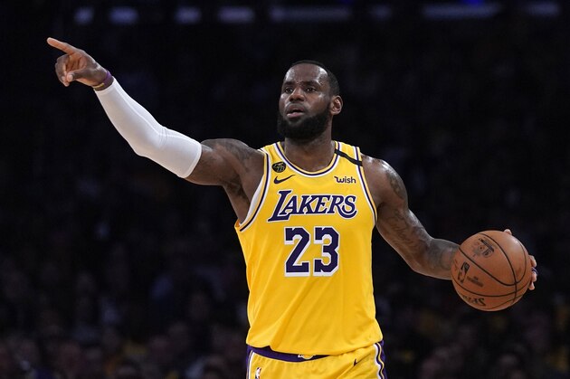 Los Angeles Lakers forward LeBron James gestures to teammates during the second half of an NBA basketball game against the Milwaukee Bucks Friday, March 6, 2020, in Los Angeles. (AP Photo/Mark J. Terrill)
