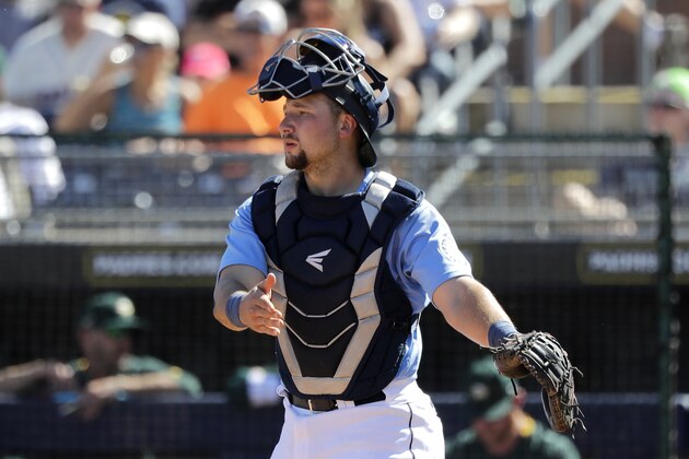 Seattle Mariners catcher Cal Raleigh looks on during a spring training baseball game Saturday, March 7, 2020, in Peoria, Ariz. (AP Photo/Elaine Thompson)