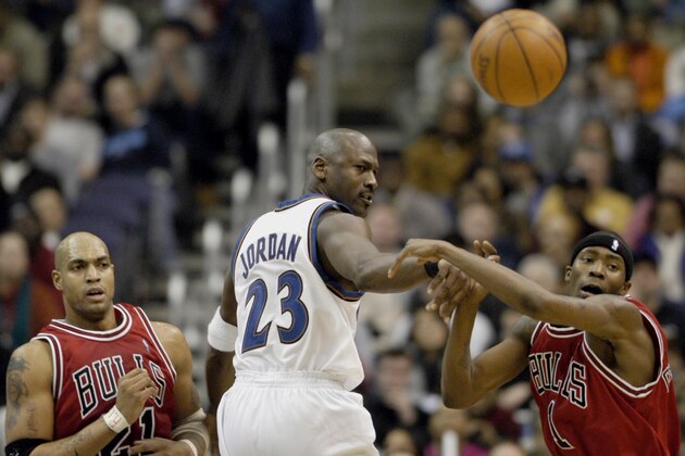 Washington Wizards' Michael Jordan (23) gets a pass off between Chicago Bulls' Marcus Fizer (21) and Jamal Crawford, right, during the fourth quarter of the Wizards' 101-98 win, Wednesday, Jan. 8, 2003, in Washington. (AP Photo/Ricky Carioti) Washington Wizards' Michael Jordan (23) gets a pass off between Chicago Bulls' Marcus Fizer (21) and Jamal Crawford, right, during the fourth quarter of the Wizards' 101-98 win, Wednesday, Jan. 8, 2003, in Washington. (AP Photo/Ricky Carioti)