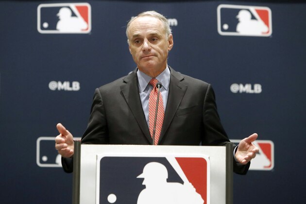 FILE - In this Nov. 21, 2019, file photo, baseball commissioner Rob Manfred speaks to the media at the owners meeting in Arlington, Texas. Major League Baseball is cutting the salary of senior staff by an average of 35% for this year and is guaranteeing paychecks to its full-time employees of its central office through May. Baseball Commissioner Rob Manfred made the announcement Tuesday, April 14, 2020.  (AP Photo/LM Otero, File)