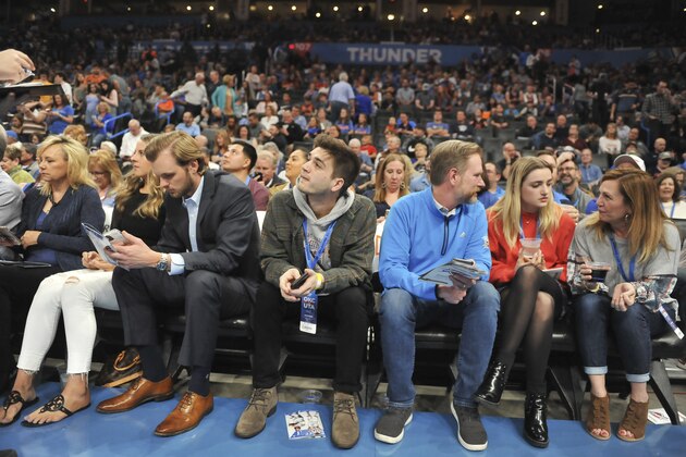 Fans wait for an announcement on the status of an an NBA basketball game between Oklahoma City Thunder and Utah Jazz in Oklahoma City, Wednesday, March 11, 2020. (AP Photo/Kyle Phillips)