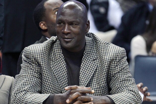 FILE - In this Jan. 14, 2012 file photo, Charlotte Bobcats basketball team owner Michael Jordan watches during the first half of an NBA basketball game between the Charlotte Bobcats and the Golden State Warriors in Charlotte, N.C. Tuesday, Aug. 7, 2012. President Barack Obama is joining with NBA legend Michael Jordan and an array of basketball stars to raise money for his re-election campaign later this month. The Obama campaign is planning a fundraising