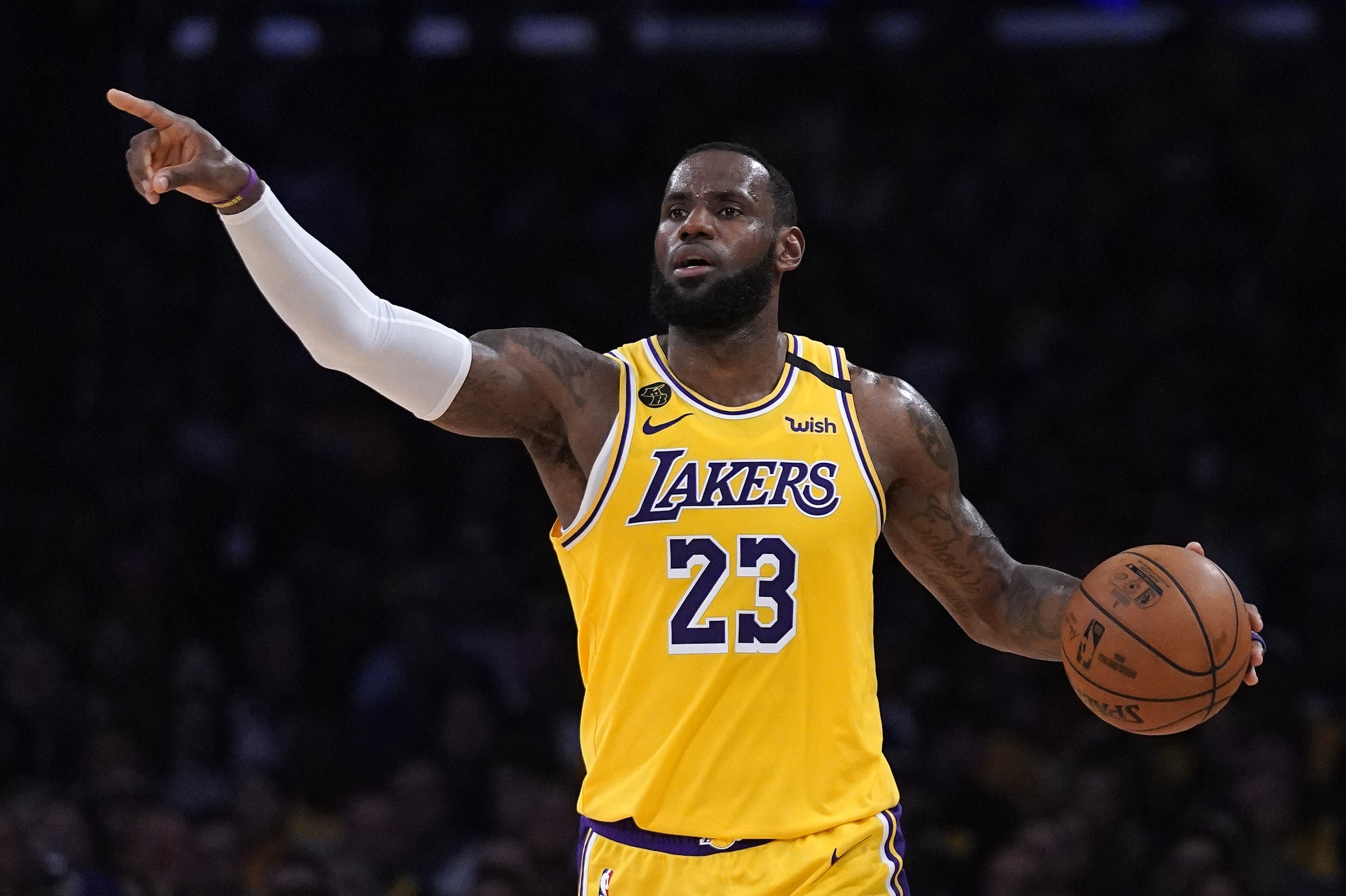 Los Angeles Lakers forward LeBron James gestures to teammates during the second half of an NBA basketball game against the Milwaukee Bucks Friday, March 6, 2020, in Los Angeles. (AP Photo/Mark J. Terrill)