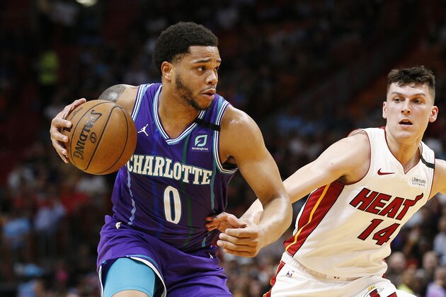 MIAMI, FLORIDA - MARCH 11:  Miles Bridges #0 of the Charlotte Hornets dribbles with the ball against Tyler Herro #14 of the Miami Heat during the first half at American Airlines Arena on March 11, 2020 in Miami, Florida. NOTE TO USER: User expressly acknowledges and agrees that, by downloading and/or using this photograph, user is consenting to the terms and conditions of the Getty Images License Agreement. (Photo by Michael Reaves/Getty Images)
