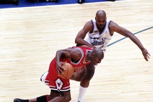 SALT LAKE CITY, UT - JUNE 14: Michael Jordan #23 of the Chicago Bulls dribbles past Bryon Russell #3 of the Utah Jazz prior to shooting the game winning jumpshot during game six of the 1998 NBA Finals played on June 14, 1998 at the Delta Center in Salt Lake City, Utah. NOTE TO USER: User expressly acknowledges and agrees that, by downloading and/or using this Photograph, User is consenting to the terms and conditions of the Getty Images License Agreement. Mandatory copyright notice and Credit:  Copyright 1998 NBAE  (Photo by Scott Winterton/NBAE via Getty Images)