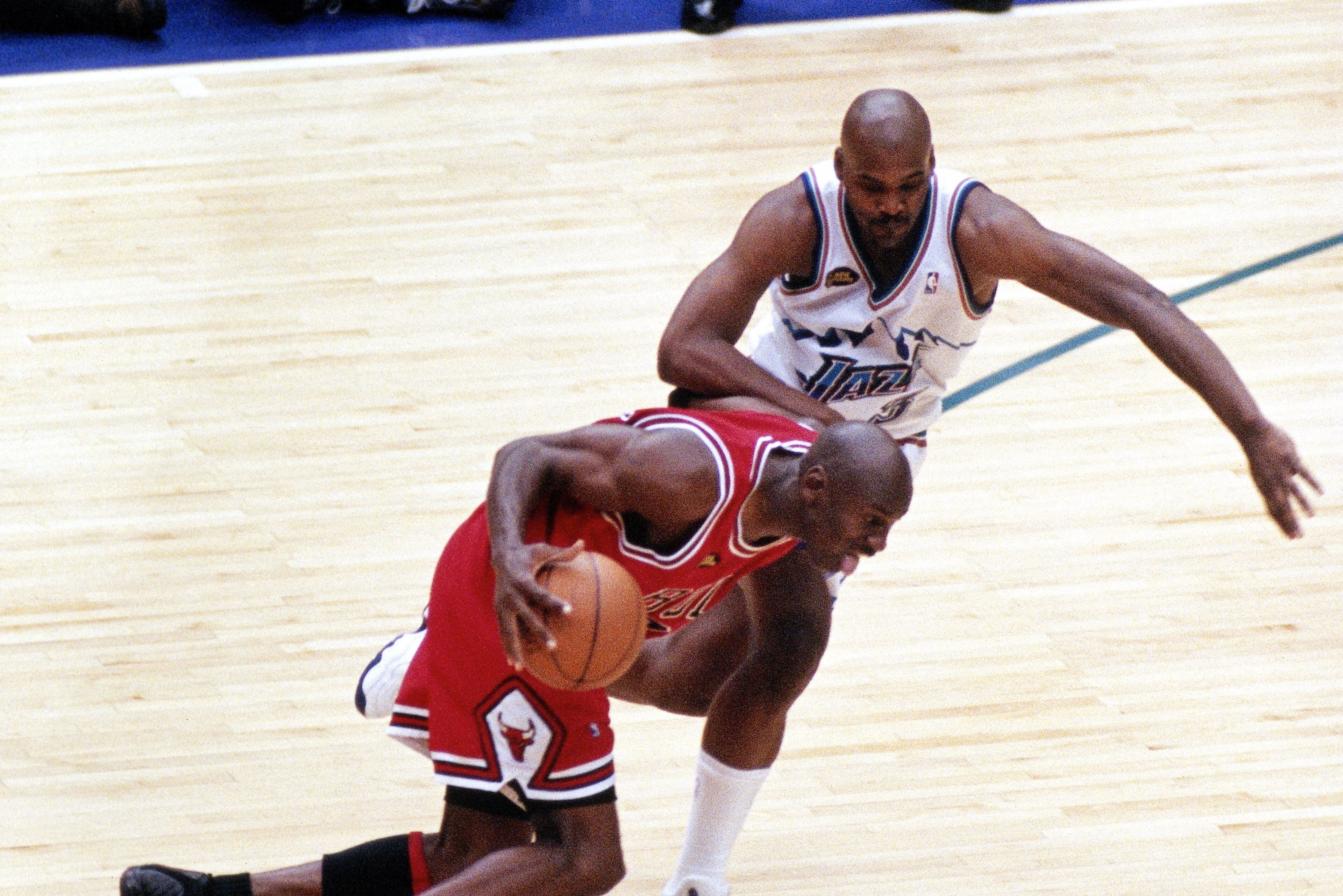 SALT LAKE CITY, UT - JUNE 14: Michael Jordan #23 of the Chicago Bulls dribbles past Bryon Russell #3 of the Utah Jazz prior to shooting the game winning jumpshot during game six of the 1998 NBA Finals played on June 14, 1998 at the Delta Center in Salt Lake City, Utah. NOTE TO USER: User expressly acknowledges and agrees that, by downloading and/or using this Photograph, User is consenting to the terms and conditions of the Getty Images License Agreement. Mandatory copyright notice and Credit:  Copyright 1998 NBAE  (Photo by Scott Winterton/NBAE via Getty Images)