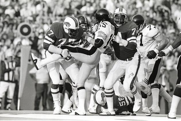 ORCHARD PARK, NY - AUGUST 4:  Defensive linemen Ben Williams #77 and Dee Hardison #74 of the Buffalo Bills tackle quarterback Mike Kruczek #15 of the Pittsburgh Steelers during a preseason game at Rich Stadium on August 4, 1979 in Orchard Park, New York.  (Photo by George Gojkovich/Getty Images)