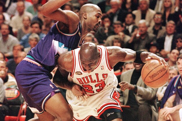 Michael Jordan (R) of the Chicago Bulls tries to get past Bryon Russell (L) of the Utah Jazz 12 June during game five of the NBA Finals at the United Center in Chicago, IL. The Bulls lead the best-of-seven series 3-1. AFP PHOTO/Jeff HAYNES (Photo by JEFF HAYNES / AFP) (Photo by JEFF HAYNES/AFP via Getty Images) Michael Jordan (R) of the Chicago Bulls tries to get past Bryon Russell (L) of the Utah Jazz 12 June during game five of the NBA Finals at the United Center in Chicago, IL. The Bulls lead the best-of-seven series 3-1. AFP PHOTO/Jeff HAYNES (Photo by JEFF HAYNES / AFP) (Photo by JEFF HAYNES/AFP via Getty Images)