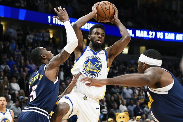 Golden State Warriors Andrew Wiggins (22) looks to make a pass as Denver Nuggets Will Baton lll (5) defends during the first half of an NBA basketball game Tuesday, March 3, 2020 in Denver (AP Photo/John Leyba) Golden State Warriors Andrew Wiggins (22) looks to make a pass as Denver Nuggets Will Baton lll (5) defends during the first half of an NBA basketball game Tuesday, March 3, 2020 in Denver (AP Photo/John Leyba)